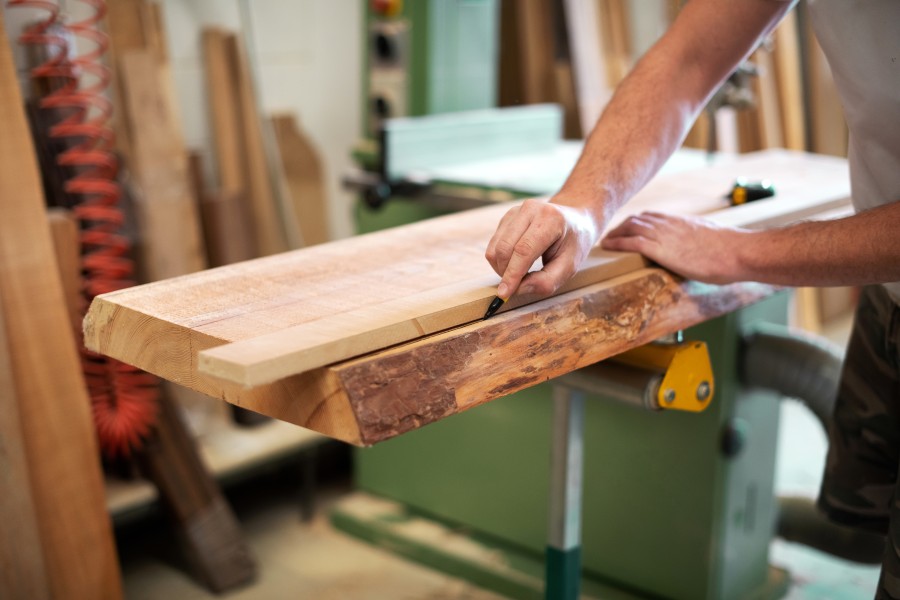 carpenter-or-woodworker-measuring-a-block-of-wood-2023-11-27-05-07-35-utc (1)
